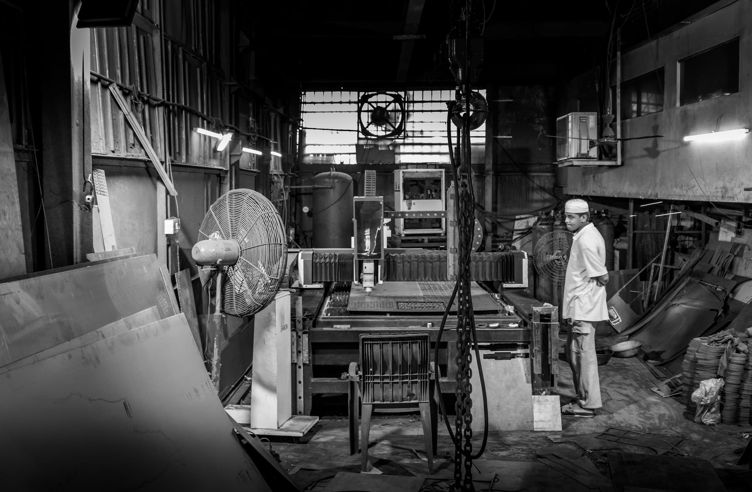 Worker in cluttered industrial workshop