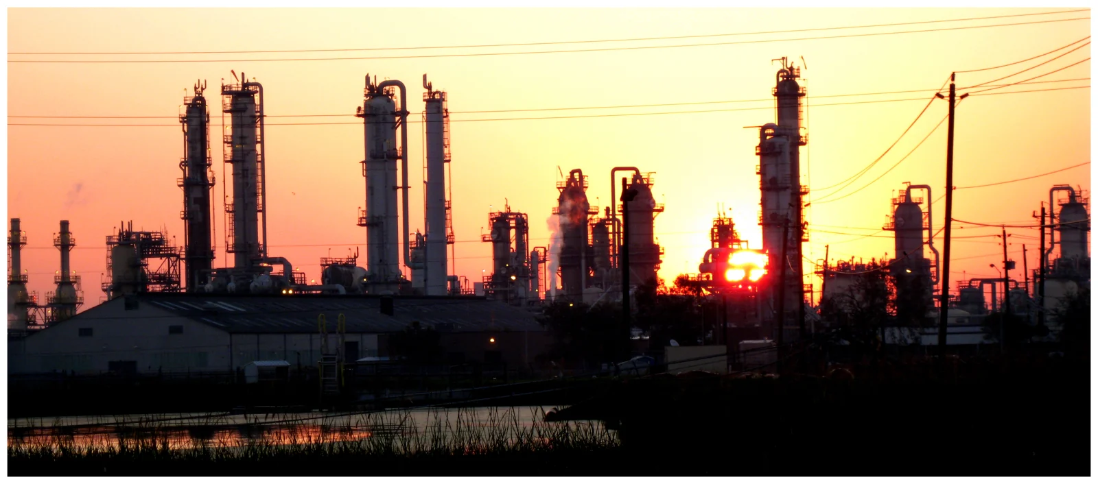 Sunrise behind the industrial skyline of a chemical plant on the Houston Ship Channel near Baytown