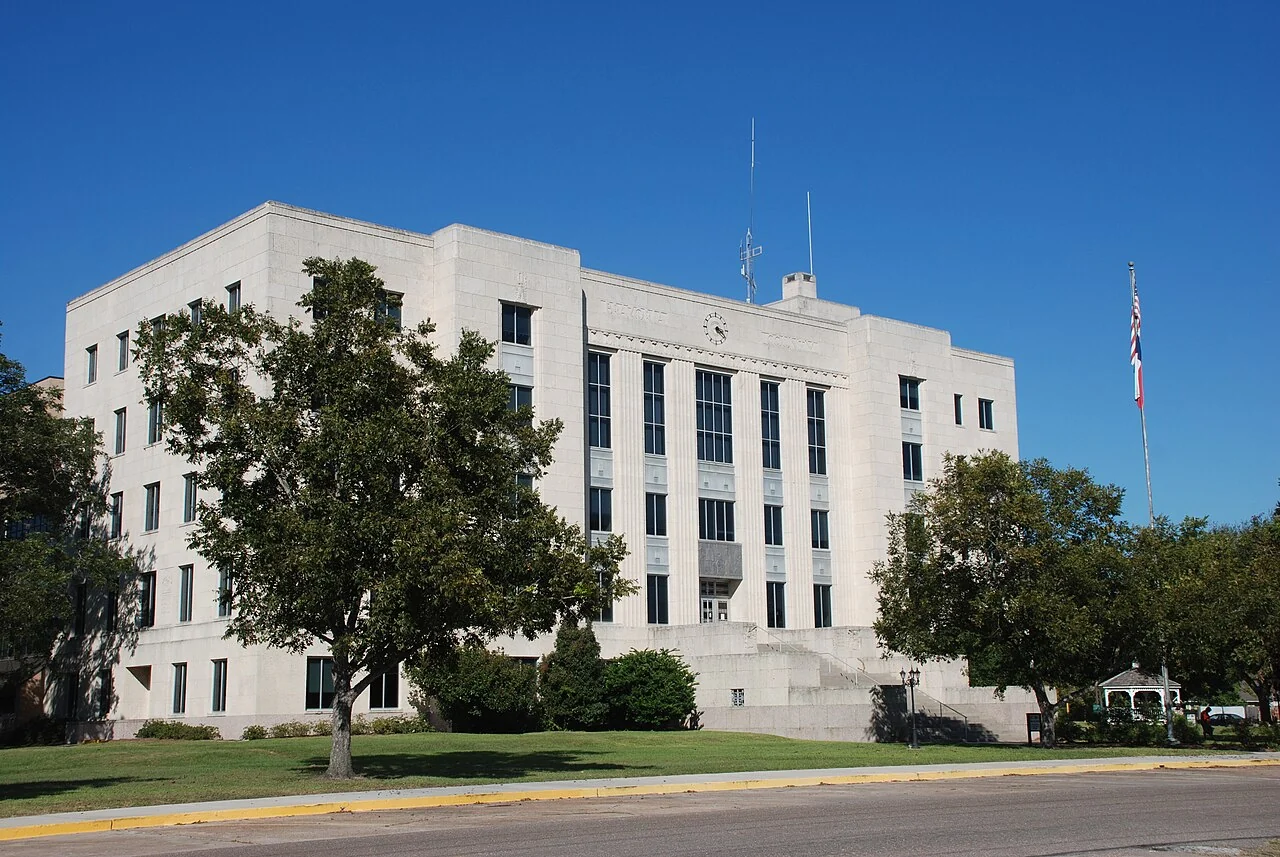 The white stone Brazoria County Courthouse in Angleton beneath a blue sky