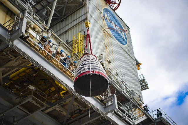 Crews lift a large rocket-engine nozzle at the Fred Haise Test Stand at Stennis in February 2024